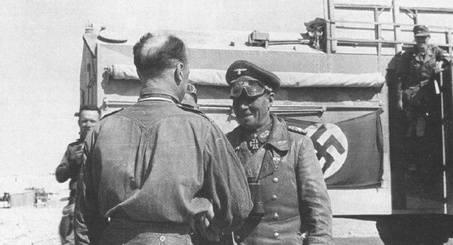 Rommel felicitando a uno de sus comandantes de campo. Al fondo el British AEC Dorchester, vehículo de británico de mando capturado por los alemanes